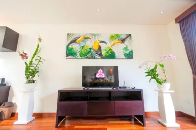 a living room with a tv on a table at Villa Bougainville in Seminyak