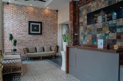 a bar with a couch and a brick wall at Villa Bougainville in Seminyak