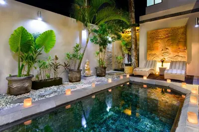 a pool in the middle of a room with plants at Super 4 Bed, Sleeps 8, Just 300m walk from Beach in Legian