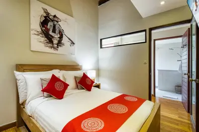 a bedroom with a bed with red pillows at Super 4 Bed, Sleeps 8, Just 300m walk from Beach in Legian