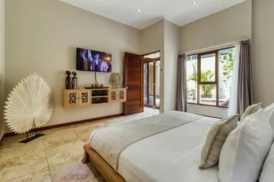 a bedroom with a large bed and a large window at Super 4 Bed, Sleeps 8, Just 300m walk from Beach in Legian