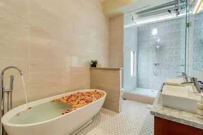 a bathroom with a tub covered in confetti at Super 4 Bed, Sleeps 8, Just 300m walk from Beach in Legian