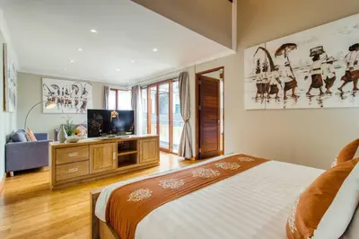 a bedroom with a bed and a flat screen tv at Super 4 Bed, Sleeps 8, Just 300m walk from Beach in Legian