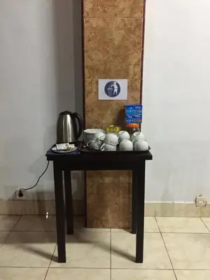 a table with a tea pot on top of it at Ratih Bali Hostel in Denpasar