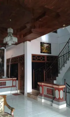 a lobby with a staircase in a building at Ratih Bali Hostel in Denpasar