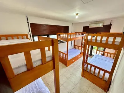 a room with three bunk beds in it at Rodin Bali Hostel in Seminyak