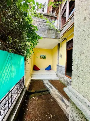 a room with a bed in the side of a building at Rodin Bali Hostel in Seminyak