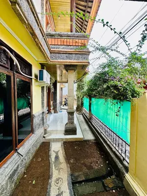 a building with a column in the middle of a street at Rodin Bali Hostel in Seminyak