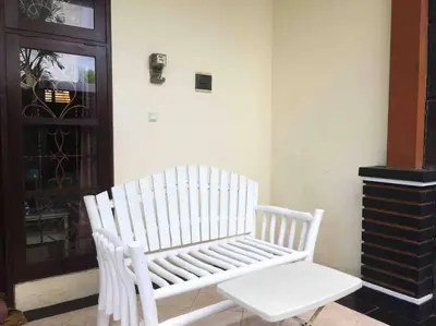 a white bench sitting in the corner of a room at simple apartment 2 in Seminyak