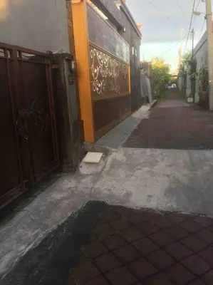 an empty alley with a building and a door at simple apartment 2 in Seminyak