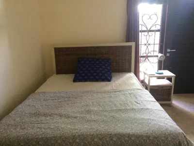 a bedroom with a bed with a blue pillow and a window at Simple apartment 1 Number 146 c in Seminyak