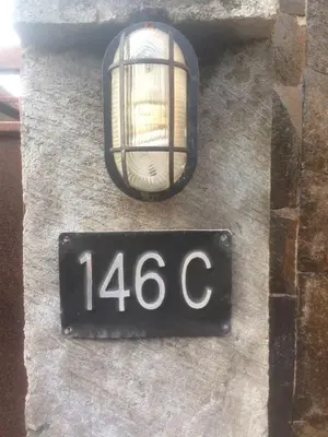 a street sign on the side of a building at Simple apartment 1 Number 146 c in Seminyak