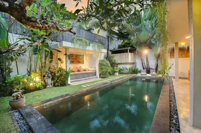 a swimming pool in the backyard of a house at Villa Malou in Seminyak