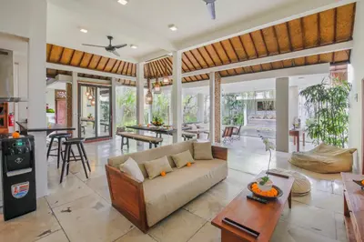 a living room with a couch and a table at Villa Malou in Seminyak