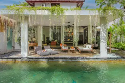 a villa with a pool in front of a house at Villa Malou in Seminyak