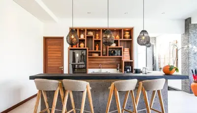 a kitchen with a large counter with stools at Stunning 6 Bedroom Villa Only 400m to the Beach in Canggu