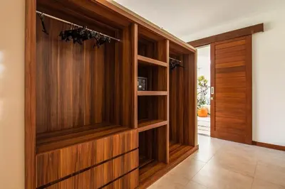 a hallway with wood paneling and a door at Stunning 6 Bedroom Villa Only 400m to the Beach in Canggu