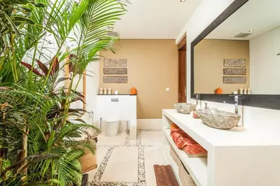 a bathroom with two sinks and plants at Stunning 6 Bedroom Villa Only 400m to the Beach in Canggu