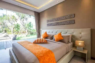 a bedroom with a large bed and a large window at Stunning 6 Bedroom Villa Only 400m to the Beach in Canggu