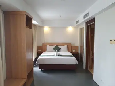 a bedroom with a large bed in a room at Paragon Hotel Seminyak in Seminyak