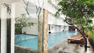 a swimming pool in the middle of a building at Paragon Hotel Seminyak in Seminyak