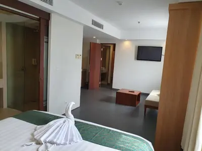 a hotel room with a bed and a television at Paragon Hotel Seminyak in Seminyak