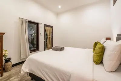a bedroom with a white bed and a window at Alex Villas Coco - Seminyak in Seminyak