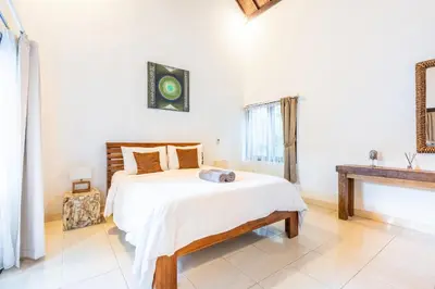 a bedroom with a bed and a sink at Alex Villas Coco - Seminyak in Seminyak
