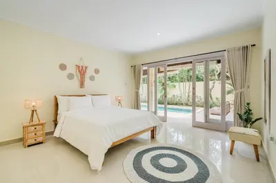 a bedroom with a bed and a pool at Villa Melati - Seminyak in Seminyak
