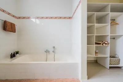 a white bathroom with a tub in a room at Villa Melati - Seminyak in Seminyak