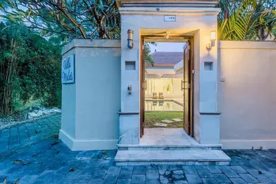 an open door to a house with a yard at Villa Melati - Seminyak in Seminyak