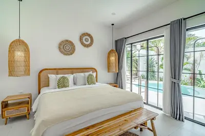 a bedroom with a bed and a large window at Villa Lemone 3 by Bali Villa Solutions in Seminyak