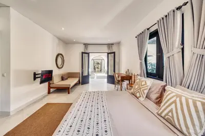 a living room with a couch and a table at Villa Arca Seminyak by Santi Management in Seminyak
