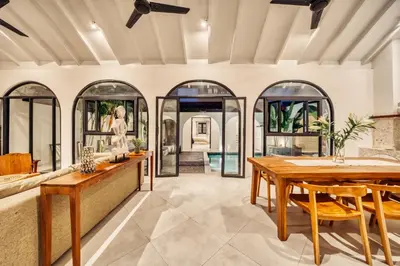 an open living room with a table and chairs at Villa Arca Seminyak by Santi Management in Seminyak