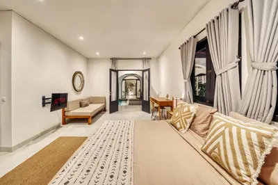 a living room with a couch and a table at Villa Arca Seminyak by Santi Management in Seminyak