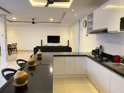 a kitchen with a black counter top in a room at Villa Akmali Umalas 2BR with Private Pool & Jacuzzi in Canggu