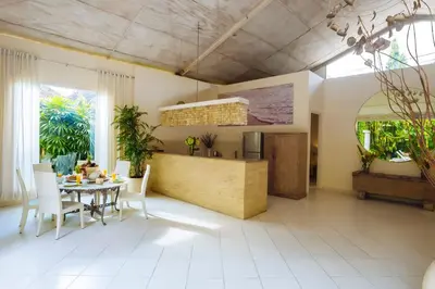 a kitchen and dining room with a table and chairs at Villa Casabola - Seminyak in Seminyak