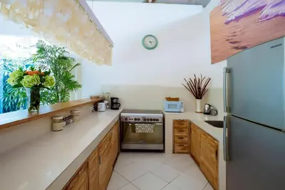 a kitchen with a stove and a refrigerator at Villa Casabola - Seminyak in Seminyak