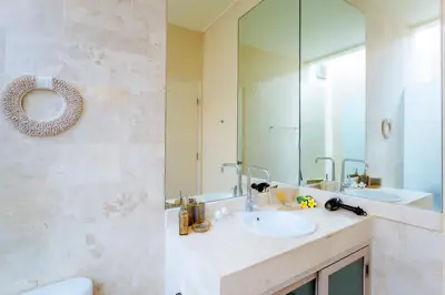 a bathroom with a sink and a mirror at Villa Casabola - Seminyak in Seminyak