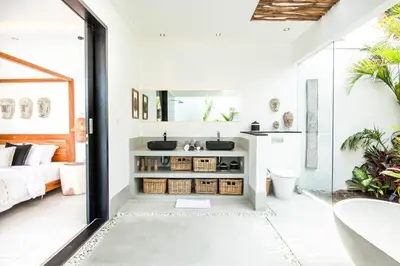 a bathroom with a double sink and a bedroom at Modern 4 BR Villa 400m to the Beach in Canggu in Canggu