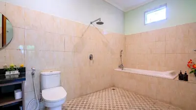 a bathroom with a toilet and a bath tub at Villa Harmony - Seminyak in Seminyak