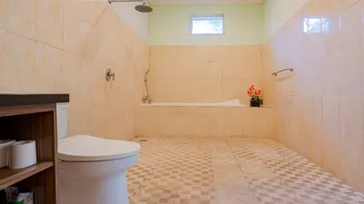 a bathroom with a toilet and a bath tub at Villa Harmony - Seminyak in Seminyak