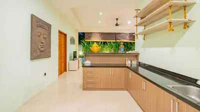 a kitchen with a sink and a counter top at Villa Harmony - Seminyak in Seminyak