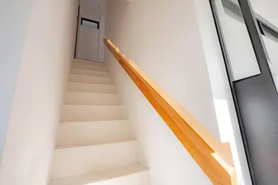 a staircase in a building with a stair case at Town House CAMY in Seminyak