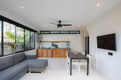 a living room with a couch and a table at Town House CAMY in Seminyak
