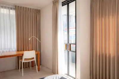 a room with a desk and a window at Town House CAMY in Seminyak