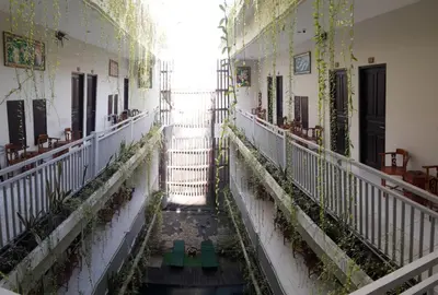 an empty hallway of a building with plants on the walls at The Agung Residence in Seminyak