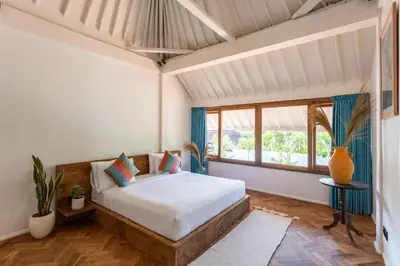 a bedroom with a bed and a large window at 2 BDR villa, walking distance to Seminyak beach. in Seminyak