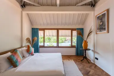 a bedroom with a large bed and a window at 2 BDR villa, walking distance to Seminyak beach. in Seminyak