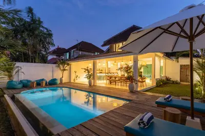 a house with a swimming pool and a wooden deck at 2 BDR villa, walking distance to Seminyak beach. in Seminyak